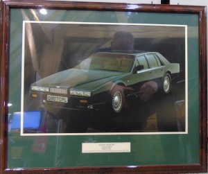 Framed photograph of an Aston Martin V8 Series 2 Lagonda, part of the V8 Aston Martin Commemorative Collection, 1969-1990 (Hunter Green Collection).